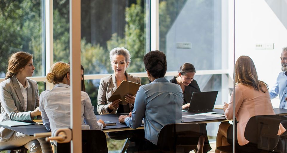 An office conference room with people meeting.